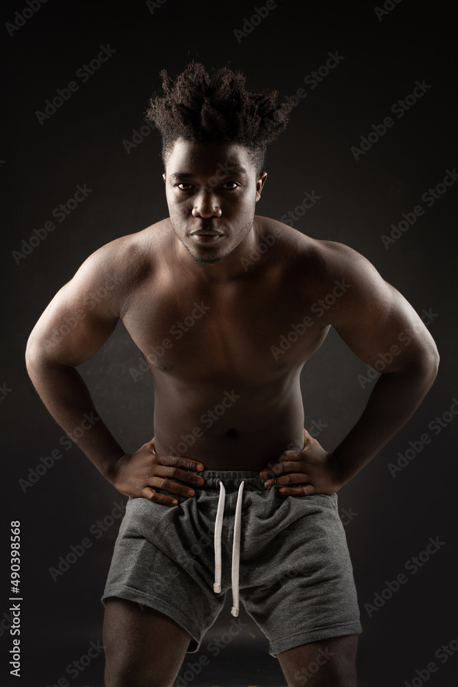 athletic figure of an African man on a black background athletic figure of an African man on a black background