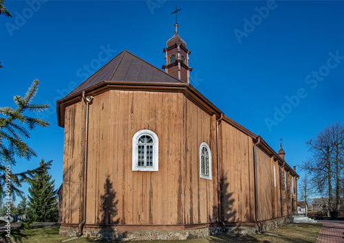 A close-up view and architectural details of the Catholic church complex erected in 1763, i.e. the belfry and the church of Saint Dorothy in the village of Domanowo in Podlasie, Poland.