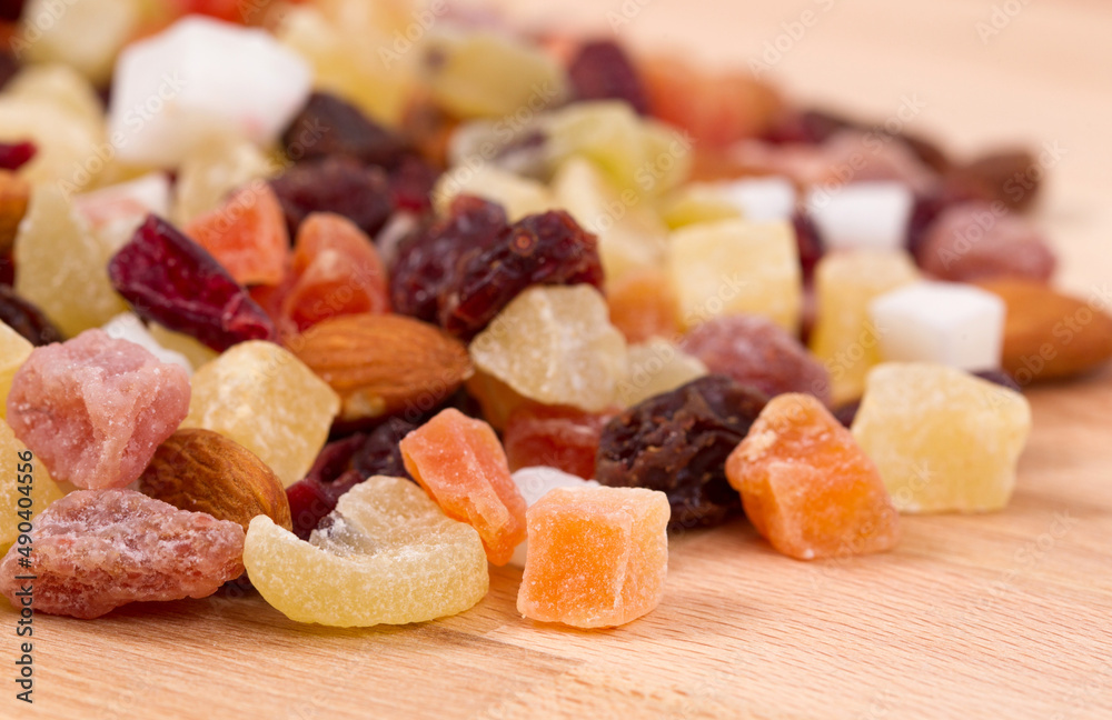 Close up of dried fruits and nuts on a wood table.