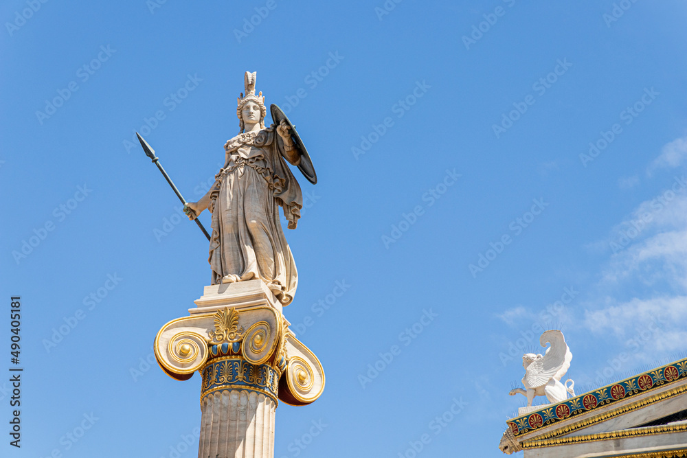 Obraz premium Athens, Greece. Column statue of godess Athena, one of the Olympian deities in classical Greek religion, in the modern Academy of Athens
