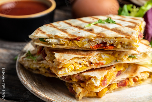 Mexican tortilla quesadilla with scramble eggs, vegetables, ham and cheese, Mexican cuisine, Mexico and Latin America traditional restaurant menu dish, food cooking recipe book cover