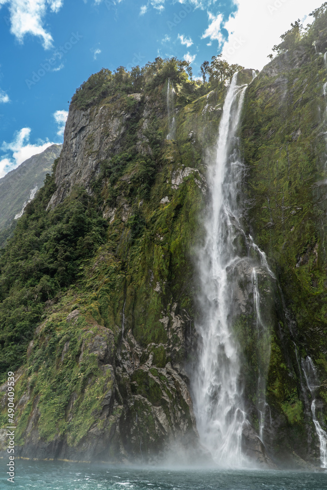 Stirling Waterfall in Milford Sound Fiordland National Park in the South Island of New Zealand on a Sunny Day Stirling Waterfall in Milford Sound Fiordland National Park in the South Island of New Zealand on a Sunny Day