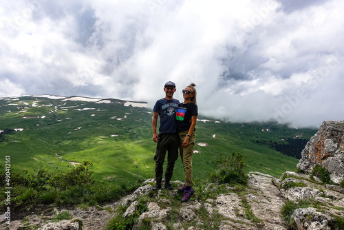 A man with a girl on the background of the alpine meadows of the Lago-Naki plateau in Adygea. Russia. 2021.