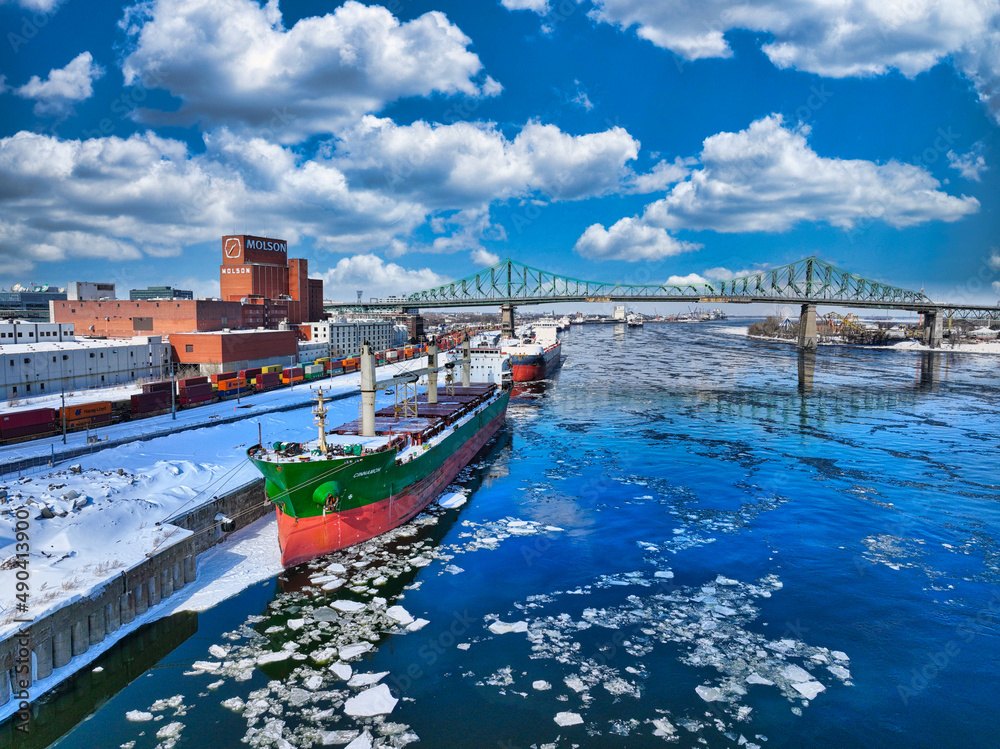 Fototapeta premium Ship waiting at Montreal Port with Jacques Cartier Bridge in background