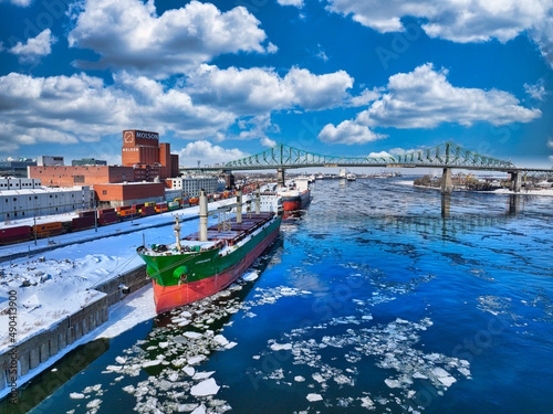 Ship waiting at Montreal Port with Jacques Cartier Bridge in background