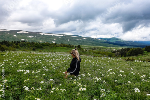 A girl on the blooming alpine meadows of Lago-Naki. Adygea. Russia 2021.