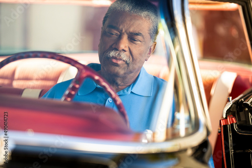 Older man sitting in drivers seat of 1960 Oldsmobile Super 88 Holiday Sport Sedan photo