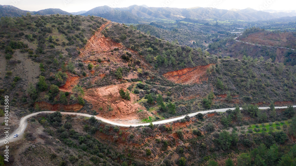 Red iron cap (gossan) on top of a hill over a metal ore deposit, Cyprus