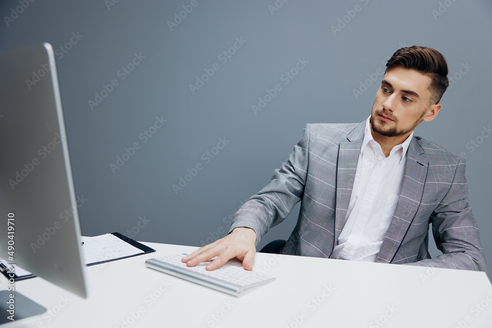 manager working at the computer in the office Gray background manager working at the computer in the office Gray background