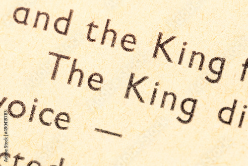 The King, printed word, text in an old antique book, macro, extreme closeup. Royalty, ruler, leader, monarchy symbol, nobility authority abstract concept, nobody, literature story, fable character