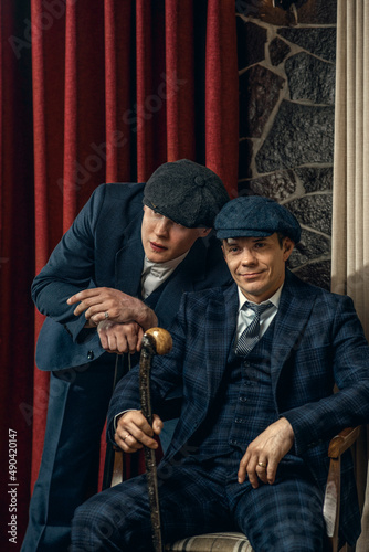 Two men in stylish suits confer,  england in 1920s theme. Peaky blinders style.
