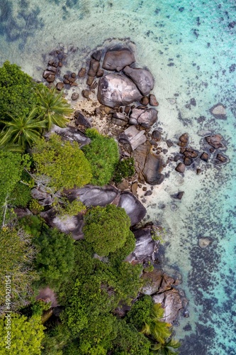 Aerial photo over Seychelles displaying the natural unspoilt beauty of the islands - from the crystal clear oceans to the lush green forests and granite boulders cascading on the white beaches. 