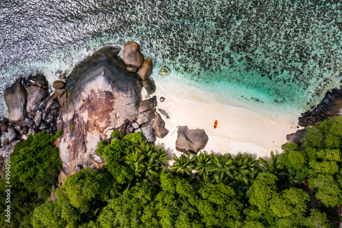Aerial photo over Seychelles displaying the natural unspoilt beauty of the islands - from the crystal clear oceans to the lush green forests and granite boulders cascading on the white beaches. 