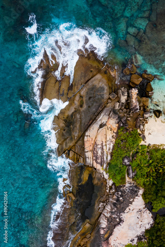 Aerial photo over Seychelles displaying the natural unspoilt beauty of the islands - from the crystal clear oceans to the lush green forests and granite boulders cascading on the white beaches. 