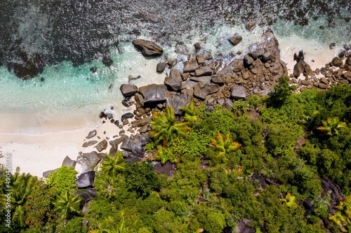Aerial photo over Seychelles displaying the natural unspoilt beauty of the islands - from the crystal clear oceans to the lush green forests and granite boulders cascading on the white beaches. 