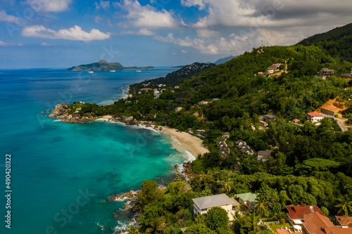 Aerial photo over Seychelles displaying the natural unspoilt beauty of the islands - from the crystal clear oceans to the lush green forests and granite boulders cascading on the white beaches. 