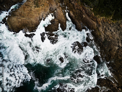 Aerial photo of the rugged coastline of Knysna, Western Cape, South Africa.  Photo taken using a drone over the cliffs, beaches and coastline.