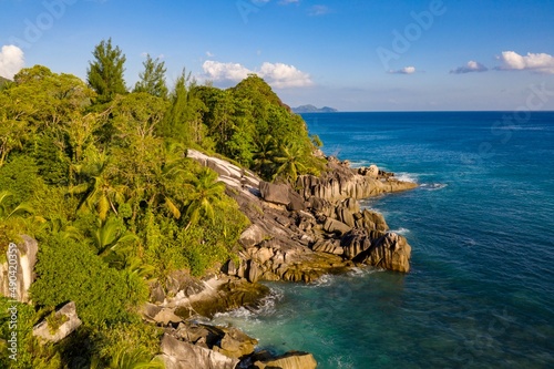 Aerial photo over Seychelles displaying the natural unspoilt beauty of the islands - from the crystal clear oceans to the lush green forests and granite boulders cascading on the white beaches. 
