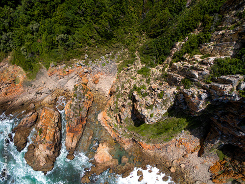 Aerial photo of the rugged coastline of Knysna, Western Cape, South Africa.  Photo taken using a drone over the cliffs, beaches and coastline.