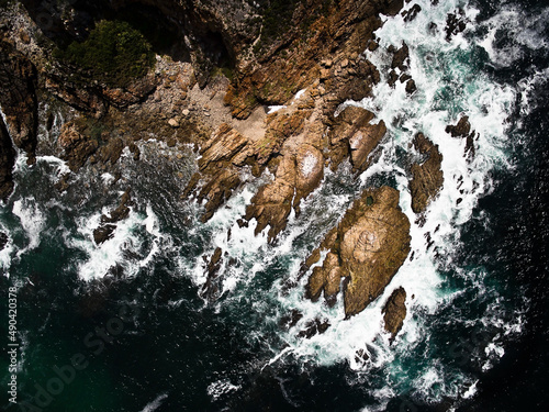 Aerial photo of the rugged coastline of Knysna, Western Cape, South Africa.  Photo taken using a drone over the cliffs, beaches and coastline.