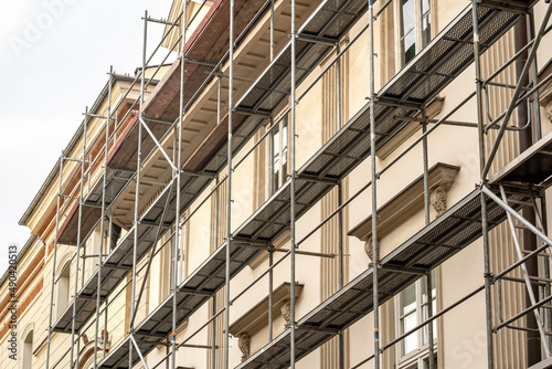 Obraz na plátně Scaffolding on a generic old tenement house, renovated historical building facade detail, closeup, nobody