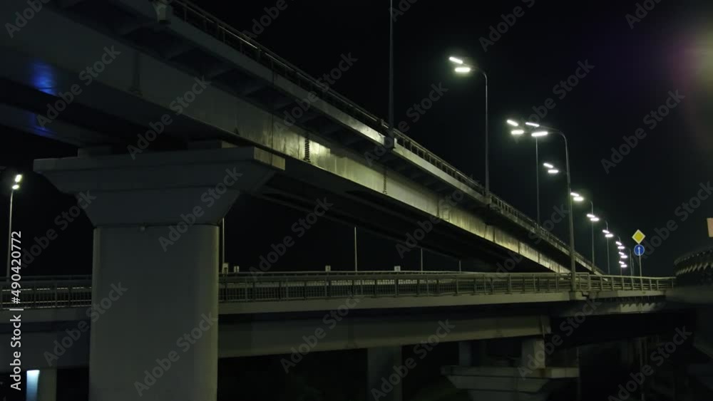 Darnitsky automobile bridge. The city of Kiev. Ukraine. Across the Dnieper River. Video from the drone. Top view of the exits from the bridge. Night. Denouement. Traffic Darnitsky automobile bridge. The city of Kiev. Ukraine. Across the Dnieper River. Video from the drone. Top view of the exits from the bridge. Night. Denouement. Traffic