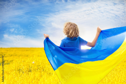 Pray for Ukraine. Child with Ukrainian flag. © famveldman