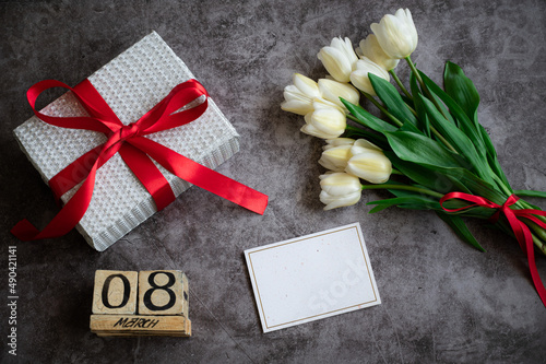 Women s day flatlay composition with gift and flowers