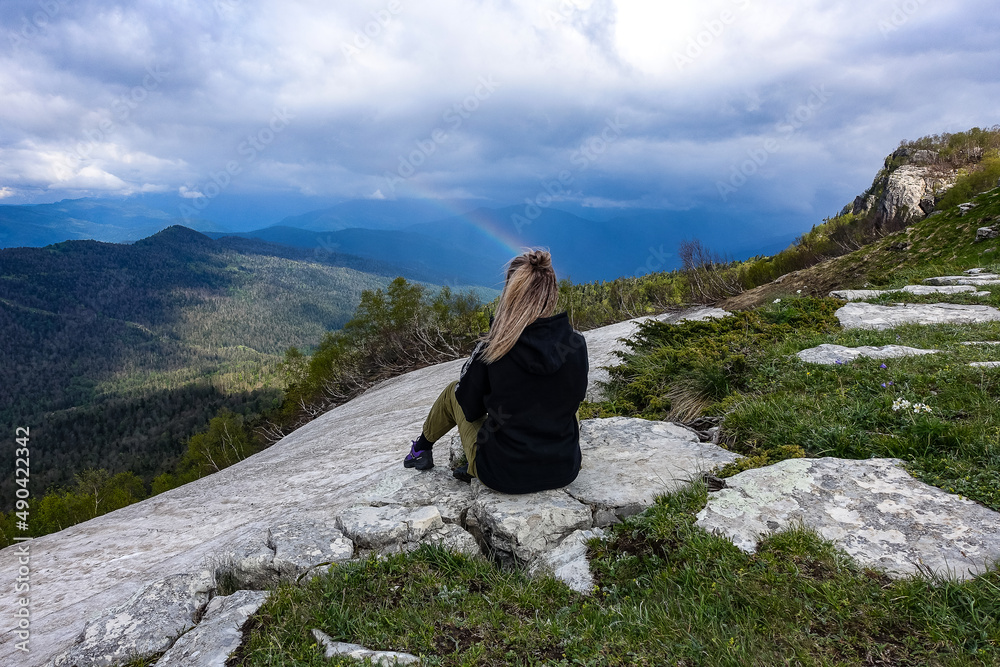 A girl on the background of alpine meadows of the Lago-Naki plateau in Adygea. Russia. 2021.