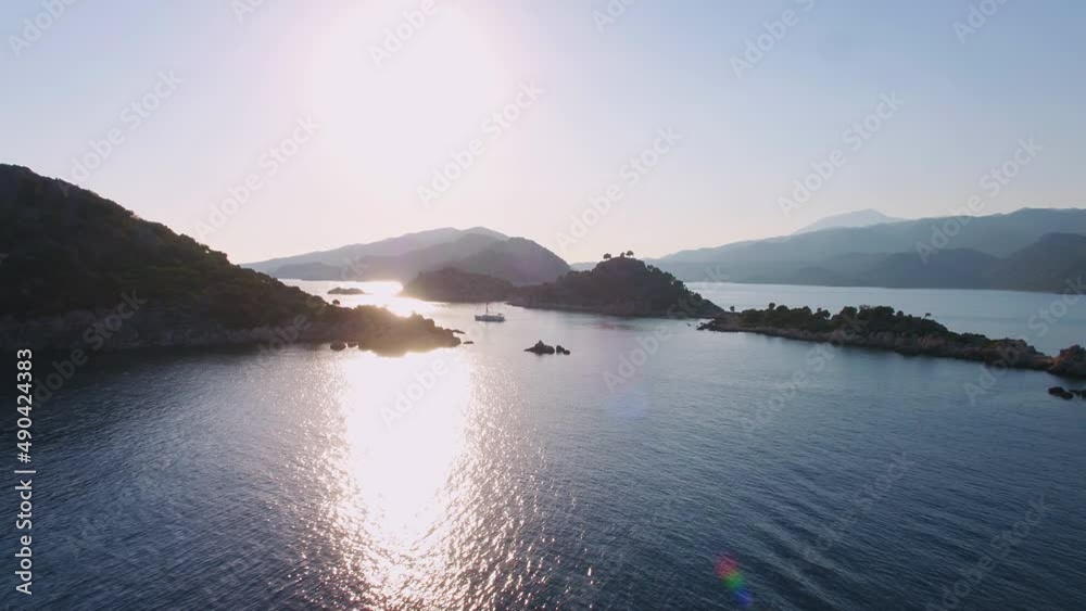 Flyover a sailboat in harsh backlight conditions at Kas Kekova area Aerial wide angle shot Flyover a sailboat in harsh backlight conditions at Kas Kekova area Aerial wide angle shot