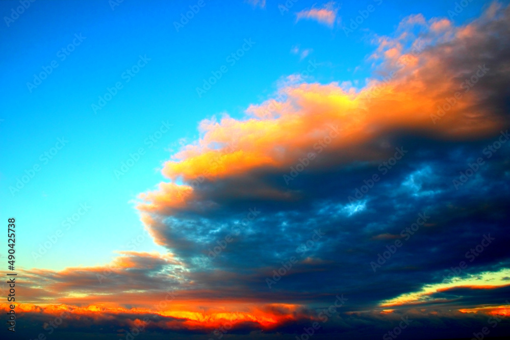 Blue sky with looming fantastic clouds during a fiery sunset in Grottammare Blue sky with looming fantastic clouds during a fiery sunset in Grottammare
