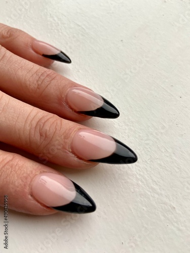 Black tip French manicure with claw points trendy nail design in acrylic applied nail art 