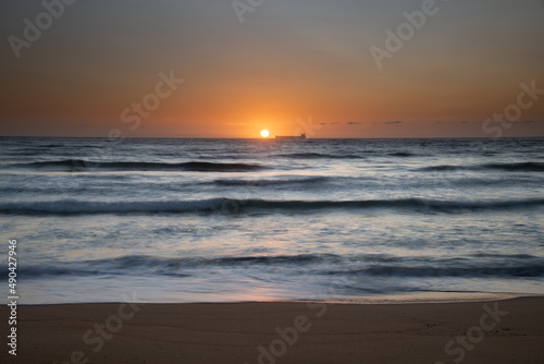 Sun, sand, ship sunrise seascape