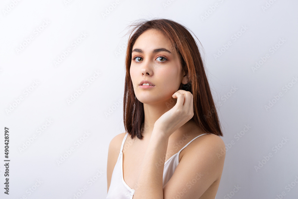 Beautiful smiling woman with clean skin, natural make-up and white teeth on a gray background Beautiful smiling woman with clean skin, natural make-up and white teeth on a gray background
