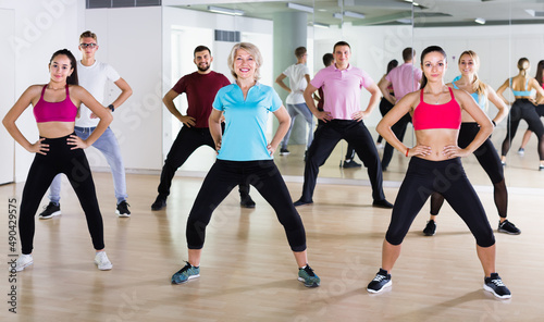 positive people dancing aerobics at lesson in the dance class