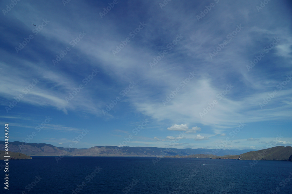 Photo of a lake, sea against the sky with clouds
