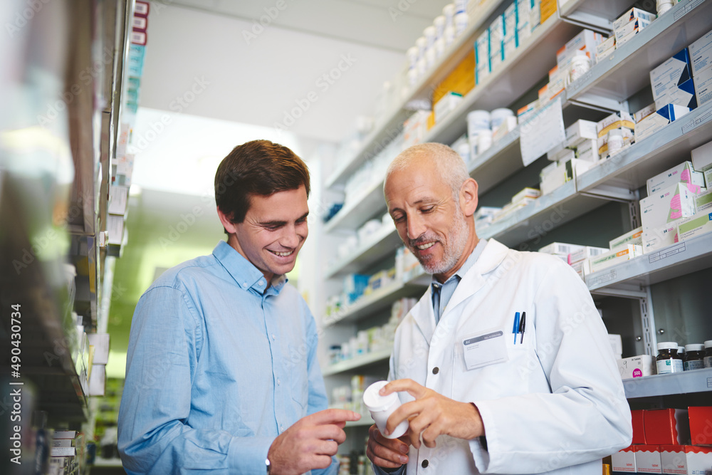Fototapeta premium This is the one you want. Cropped shot of a handsome mature male pharmacist helping a customer in the pharmacy.