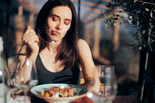 Woman Unhappy with Her Dessert Eating in a Restaurant photo