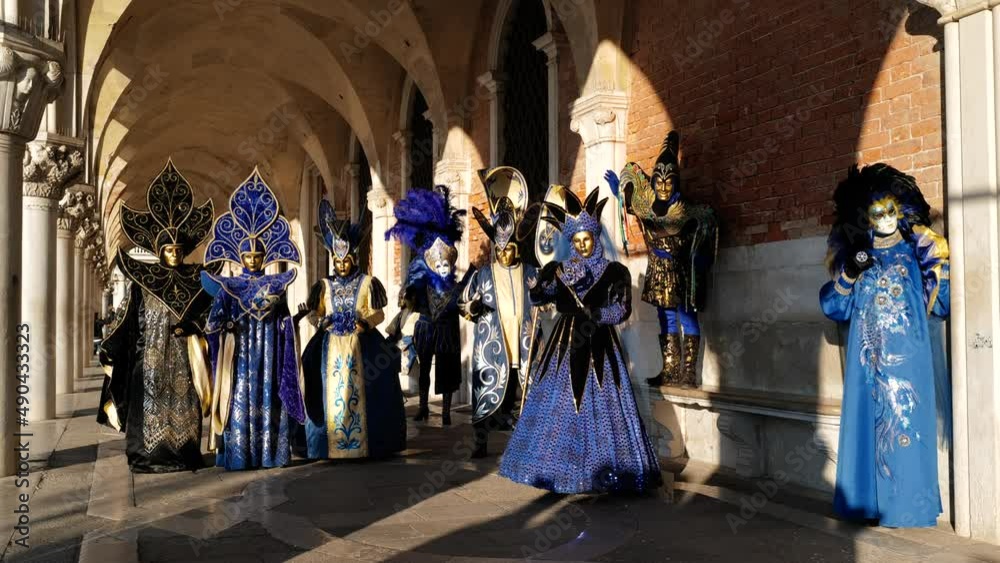 Venice, Italy - February 2022 - carnival masks are photographed with tourists in San Marco square
Venice, Italy - February 2022 - carnival masks are photographed with tourists in San Marco square