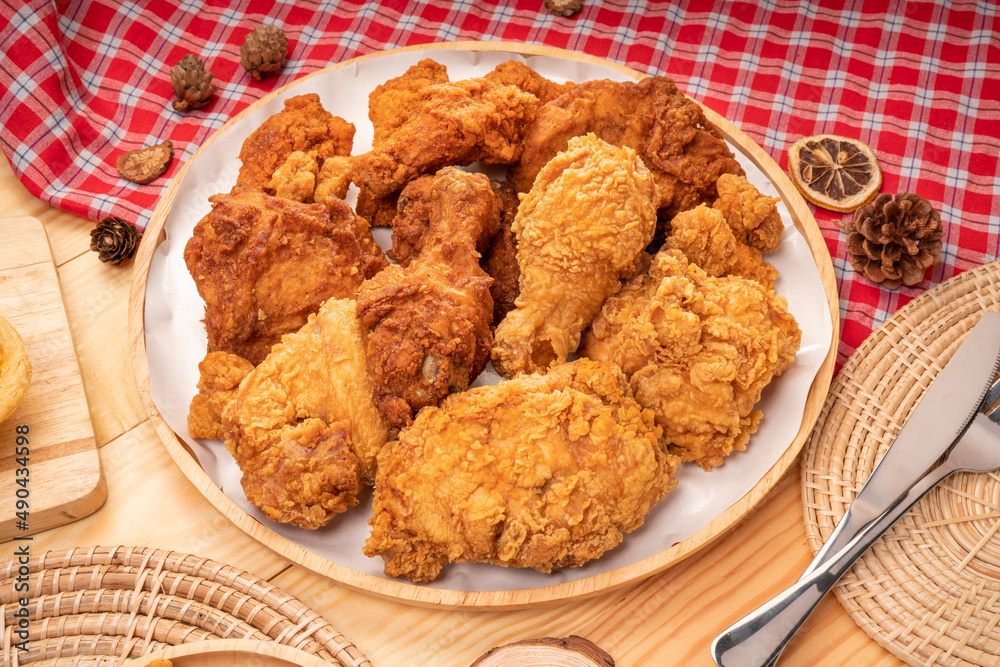 Fried chicken in wooden plate on wooden background, Deep fried Chicken on wooden table. Fried chicken in wooden plate on wooden background, Deep fried Chicken on wooden table.