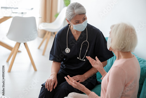 Elderly patient with nurse on appointment at home
