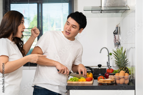 Fotografi stressed couple conflict in their kitchen, angry woman pointing hand to man for