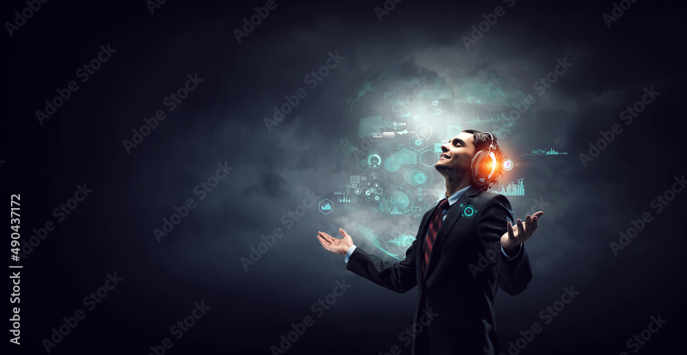 Young businessman with headphones . Mixed media Young businessman with headphones . Mixed media