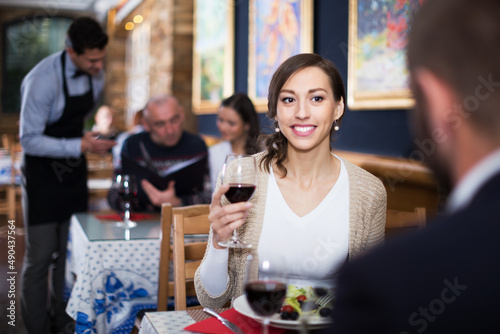 Family couple female and male celebrating anniversary with food and wine in restaurant