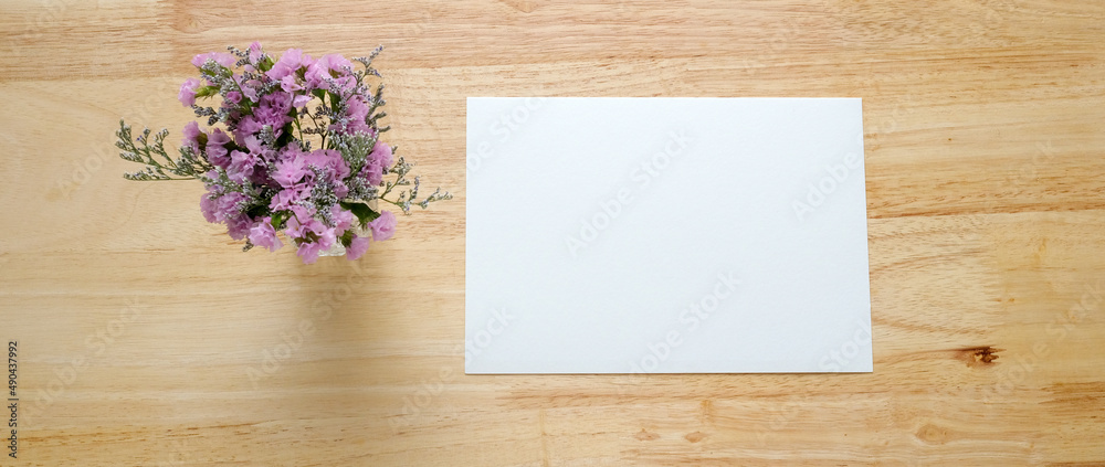 Flower bouquet and blank note paper on wood background, banner with copy space, top view, flat lay Flower bouquet and blank note paper on wood background, banner with copy space, top view, flat lay
