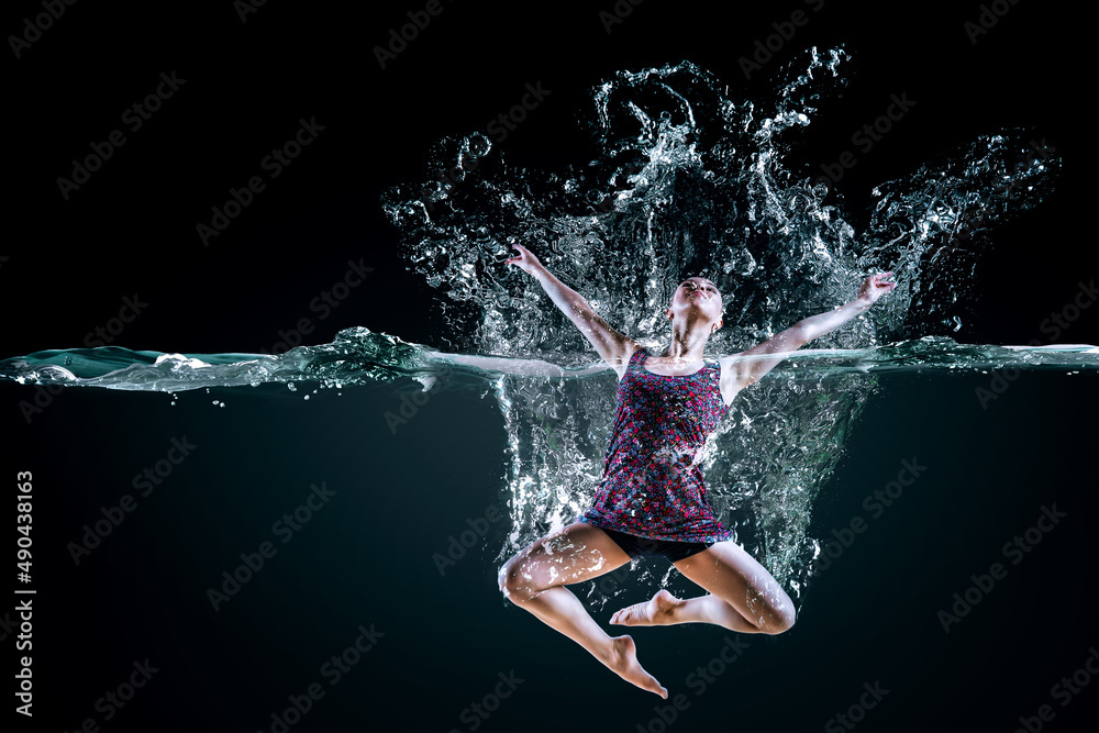 Professional woman swimmer on a wave