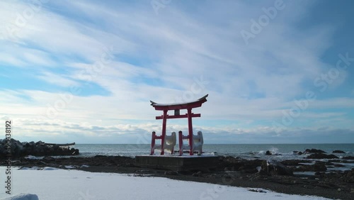 Footage of red torii gate of Konpira shrine by the sea in the snow, Shosanbetsu, Hokkaido photo