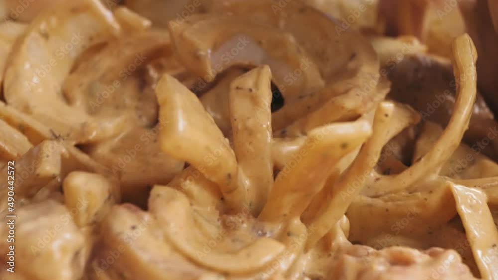 Women's hands mix chicken pieces in spices and marinade in a dish Women's hands mix chicken pieces in spices and marinade in a dish