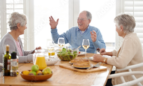 Life starts at retirement. A senior man and two senior women enjoying lunch.