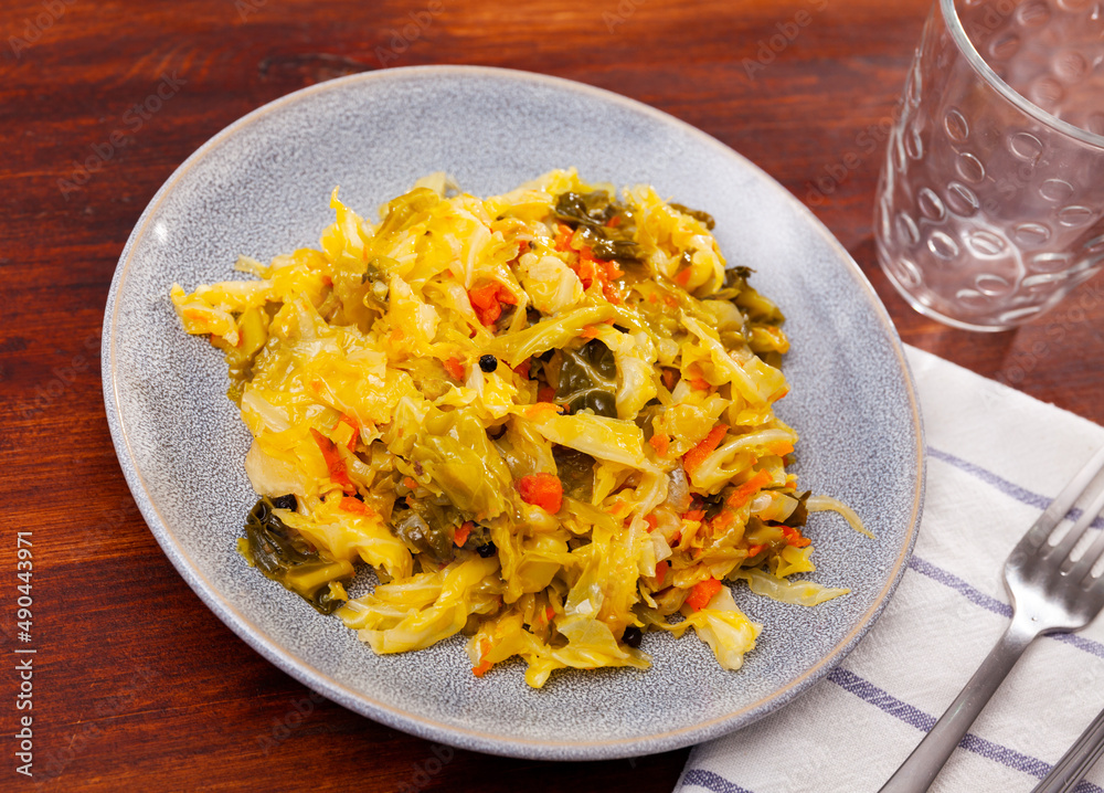 Popular dish of Russian cuisine is stewed cabbage, cooked with carrots, onions, herbs, peppers and seasonings